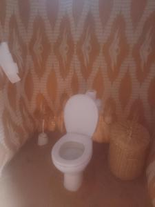 a bathroom with a white toilet in a room at Sahara family camp in Merzouga +13 photos