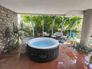 a large hot tub sitting on a patio at Pieds dans l'eau Terrace, Spa & Cactus in Bordighera