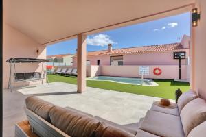 a living room with a couch and a large window at Golden dunes villa picasso in Costa de Antigua