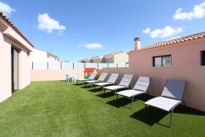 a row of chairs on the side of a building at Golden dunes villa picasso in Costa de Antigua +44 photos