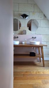a bathroom with two sinks and a mirror at La Grange in Savonnières +22 photos