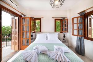 a bedroom with a large bed with white pillows at Mani Villa Ilias in Agios Nikolaos