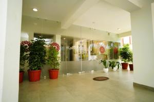 a room with many potted plants in a building at Kaibalya Bliss in Bhubaneshwar