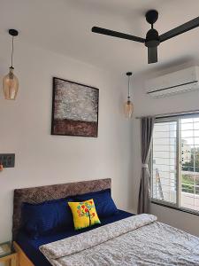 a bedroom with a bed and a ceiling fan at Miracle Stays Nashik-NEW 2BHK close to Sula and Trimbak in Nashik