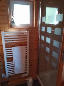a bathroom with a shower and a towel at Roulot'So Zen in Beslon