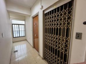 a hallway with a door with a bunch of wine bottles at Playa Bristol, frente al MAR y vista a las mejores PLAYAS de Mar del Plata, a pasos del TORREÓN y del CASINO in Mar del Plata