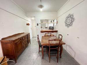 a dining room with a wooden table and chairs at Playa Bristol, frente al MAR y vista a las mejores PLAYAS de Mar del Plata, a pasos del TORREÓN y del CASINO in Mar del Plata