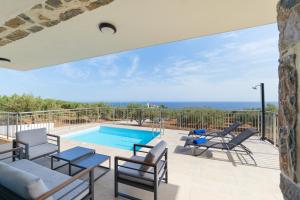 a villa with a swimming pool and a patio at Chryselia Suites- Private Pool in Keratokampos
