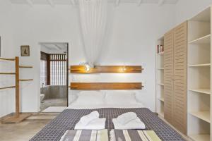 a bedroom with a bed with two towels on it at Chat Bleu in Bouillante