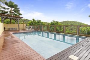 a swimming pool on the deck of a villa at Chat Bleu in Bouillante