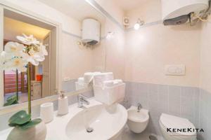 a bathroom with a sink and a toilet and a mirror at Paradise in Rudalza