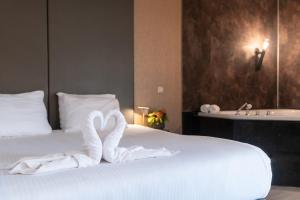Postel nebo postele na pokoji v ubytování Golden Tulip Ampt van Nijkerk