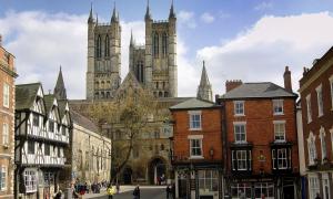 an old city with a cathedral in the background at Exchequergate in Lincoln