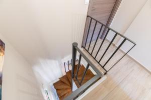a staircase in a house with a metal railing at September15 Suites, Lefkada-Episkopos in Nikiana