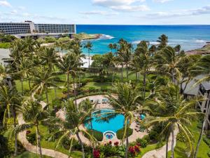 an aerial view of a resort with palm trees and a pool at Turtle Bay Villas 307 in Kahuku