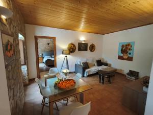 a living room with a couch and a table at Quinta do Pomarinho with private pool in Tavira