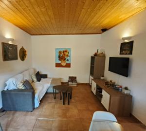 a living room with a couch and a table at Quinta do Pomarinho with private pool in Tavira
