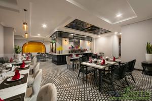 a dining room with tables and chairs in a restaurant at The Emissary Hanoi Hotel & Spa in Hanoi