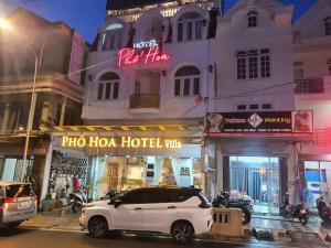 a white car parked in front of a hotel at Pho Hoa Hotel in Da Lat +34 photos