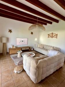 a large living room with a couch and a table at Kasa K - Slowlife in Binibeca in Binibeca +37 photos