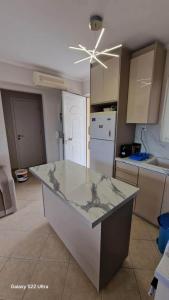 a kitchen with a marble counter top in a room at Antreas cosy apartment in Paralion astros