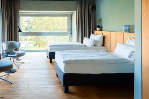 Cama ou camas em um quarto em THE FLAG West M.