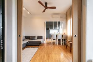 a living room with a couch and a ceiling fan at Saroko Apartment 2 in Ágios Rókkos