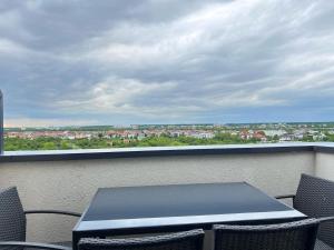a table and chairs on a balcony with a view at H Pipera - 2BR - Lake View in Voluntari