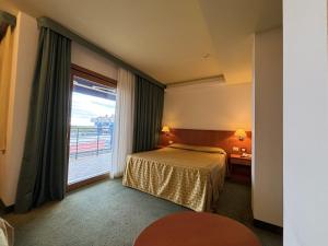 Postel nebo postele na pokoji v ubytování Hotel Rialto