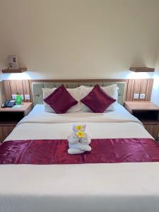a bed with a stuffed animal sitting on top of it at Casa Verde Guesthouse in Sempidi +37 photos