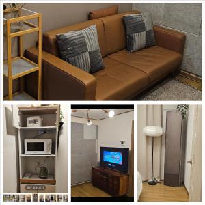 a living room with a brown couch and a tv at Dada House in Seoul