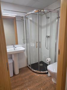 a bathroom with a shower and a toilet and a sink at ANCLA spaces EGVT-436-CS in Vinarós +10 photos