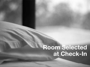 a bed with a pillow with the words room selected at check in at Hollywood Celebrity Hotel in Los Angeles