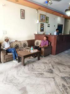 a group of people sitting in a living room at Hotel Royal Fort in Gurgaon