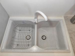 a sink with a faucet in a kitchen at Milos Pollonia Apartment in Mesochórion