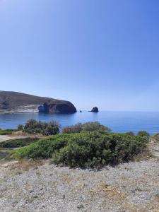 a view of the ocean with rocks in the water at Milos Pollonia Apartment in Mesochórion