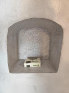 a pizza box sitting in a niche in a wall at Milos Pollonia Apartment in Mesochórion