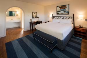 a bedroom with a large bed and a bathroom at The Milo in Santa Barbara