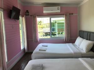 Voodi või voodid majutusasutuse Phalagoon Resort toas