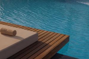 a pool with a rolled up towel next to the water at JAZ Sharm Dreams in Sharm El Sheikh