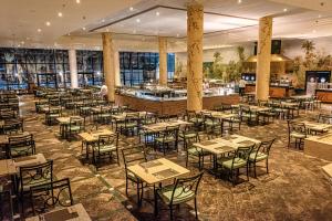 a restaurant with tables and chairs in a room at JAZ Sharm Dreams in Sharm El Sheikh