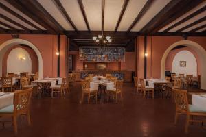 a dining room with tables and chairs and a chandelier at JAZ Sharm Dreams in Sharm El Sheikh