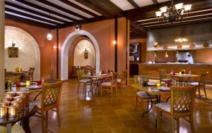 a restaurant with tables and chairs in a room at JAZ Sharm Dreams in Sharm El Sheikh