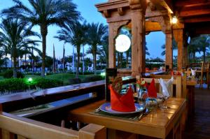 a wooden table with wine glasses on top at JAZ Sharm Dreams in Sharm El Sheikh