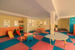 a childrens play room with tables and chairs and a table at JAZ Sharm Dreams in Sharm El Sheikh