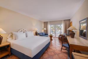 a bedroom with a large bed and a living room at JAZ Sharm Dreams in Sharm El Sheikh