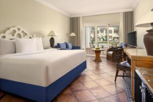 a hotel room with a large bed and a living room at JAZ Sharm Dreams in Sharm El Sheikh