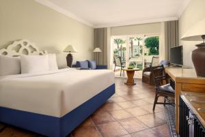 a hotel room with a bed and a living room at JAZ Sharm Dreams in Sharm El Sheikh