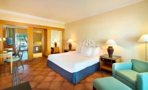 a bedroom with a bed and a living room at JAZ Sharm Dreams in Sharm El Sheikh