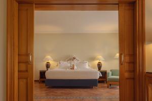 a bedroom with a bed with white sheets and pillows at JAZ Sharm Dreams in Sharm El Sheikh
